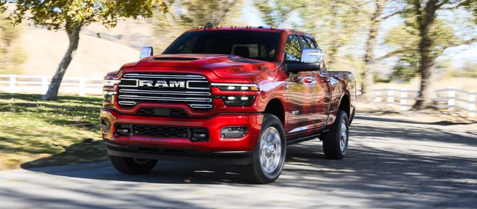 2026 Ram 2500 Trim Comparison Red 2026 RAM 2500 driving around a curved road