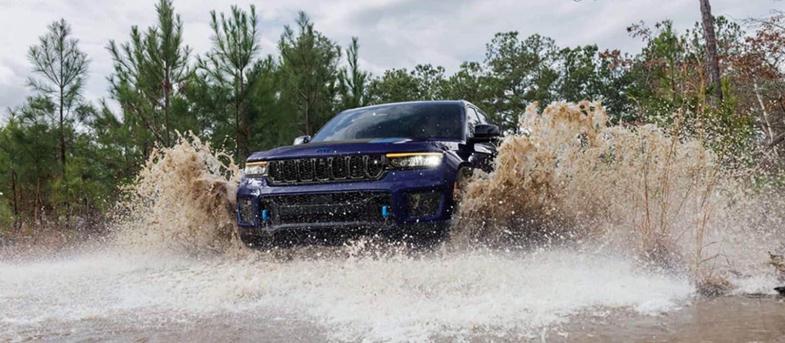 2025 Jeep Grand Cherokee Trim Comparison 2025 Jeep Grand Cherokee driving through deep water