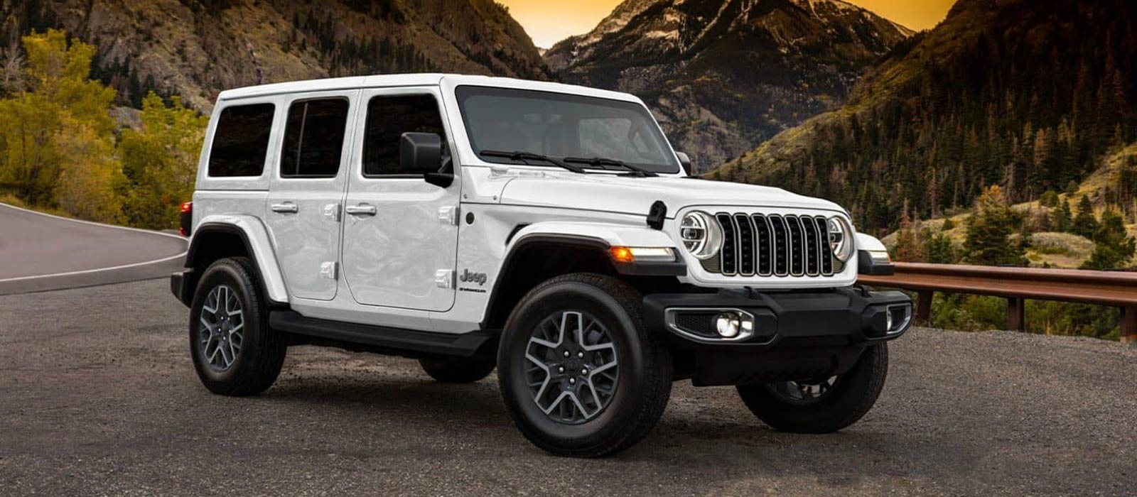 2026 Jeep Wrangler Trim Comparison White 2026 Jeep Wrangler parked in front of mountains