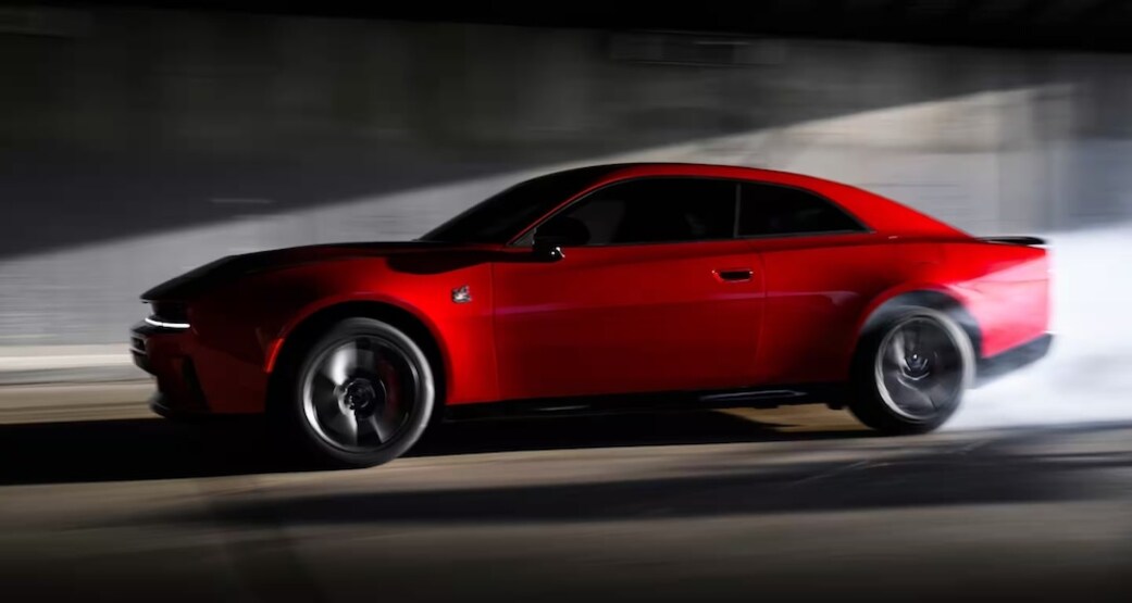 A side view of a red 2026 Dodge Charger
