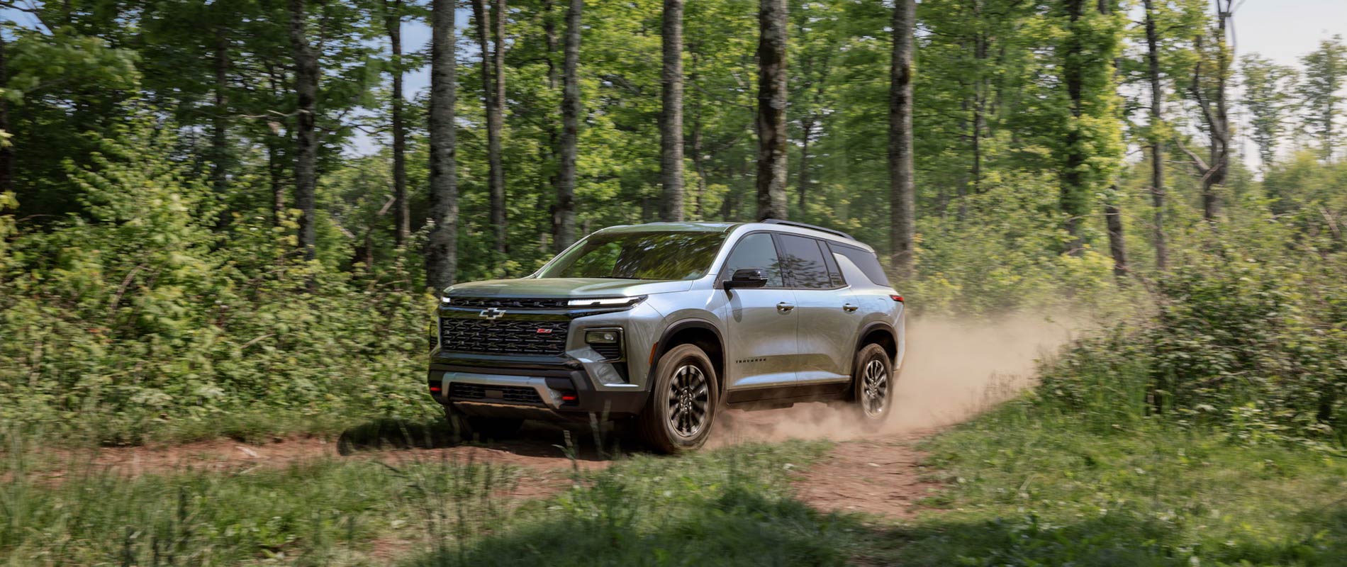2026 Chevrolet Traverse Trim Comparison 2026 Chevrolet Traverse driving through the woods