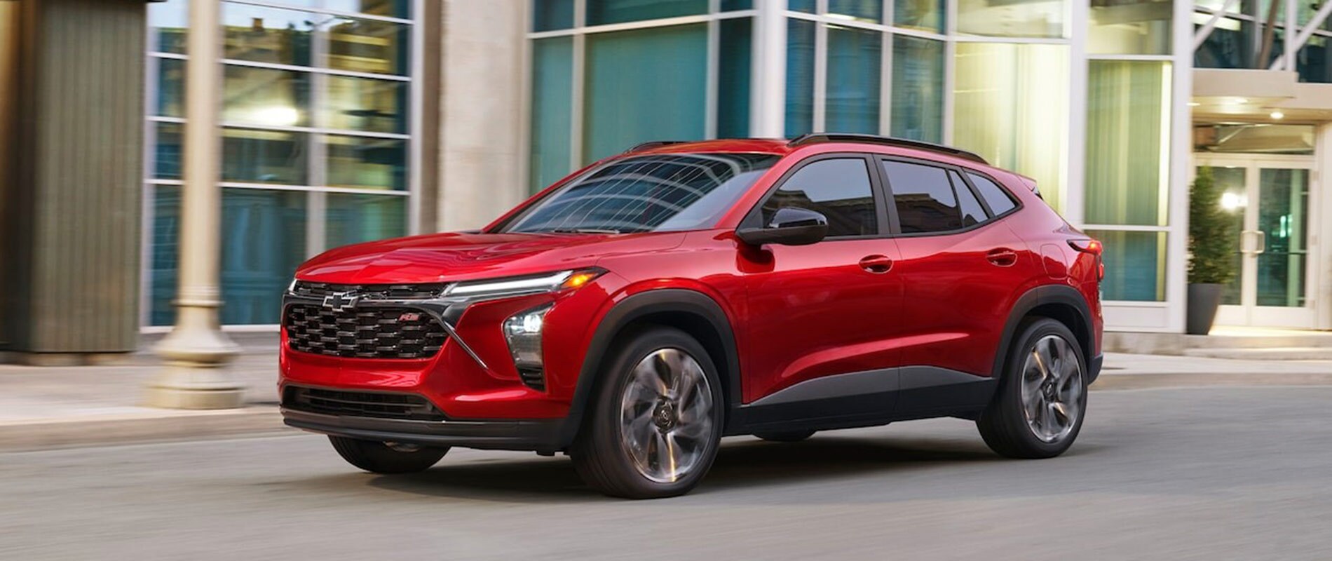 2026 Chevrolet Trax Trim Comparison Red 2026 Chevrolet Trax driving by a business