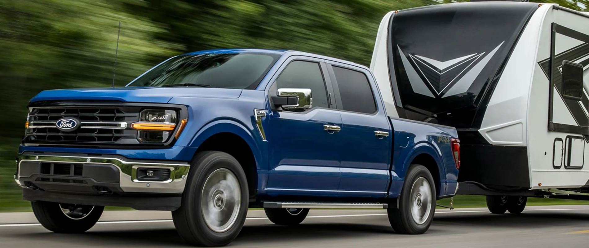 2025 Ford F-150 Trim Comparison Blue Ford F-150 pulling a camper