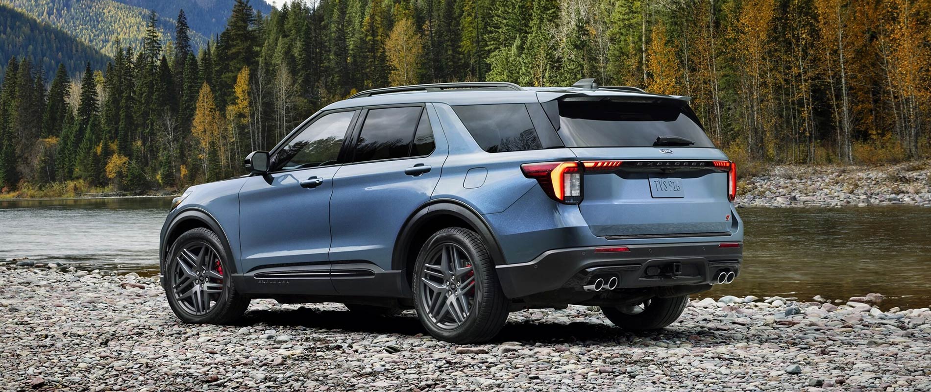 2025 Ford Trim Comparisons 2025 Ford Explorer parked beside a river in the woods