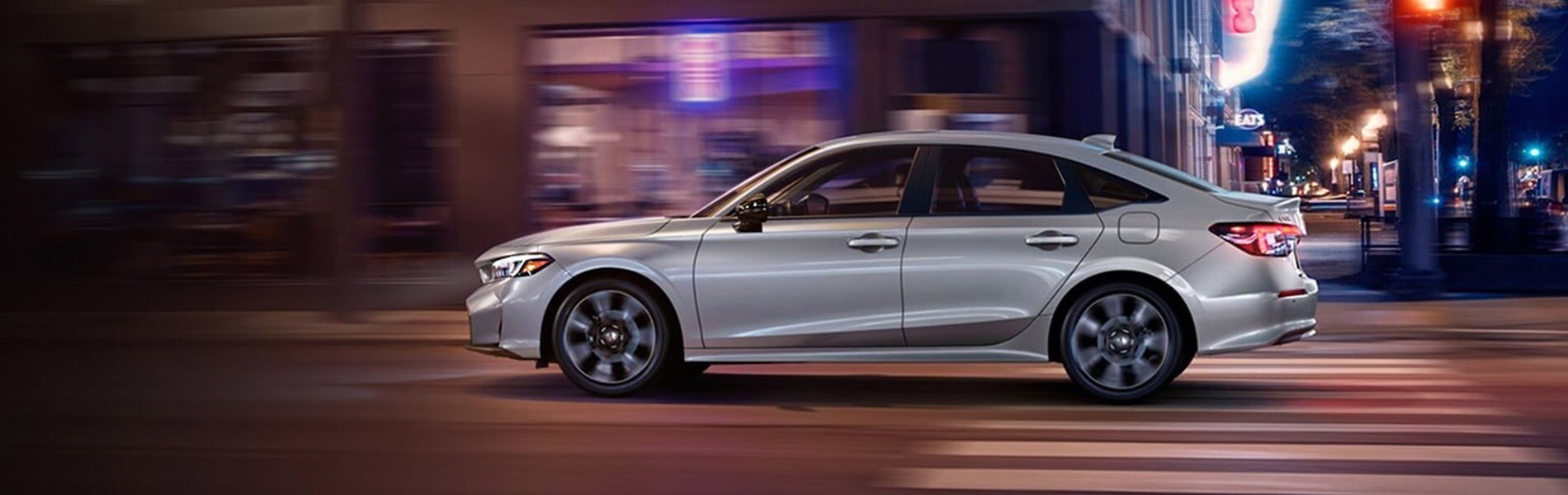 2026 Honda Civic Trim Comparison 2026 Honda Civic driving in the city at night