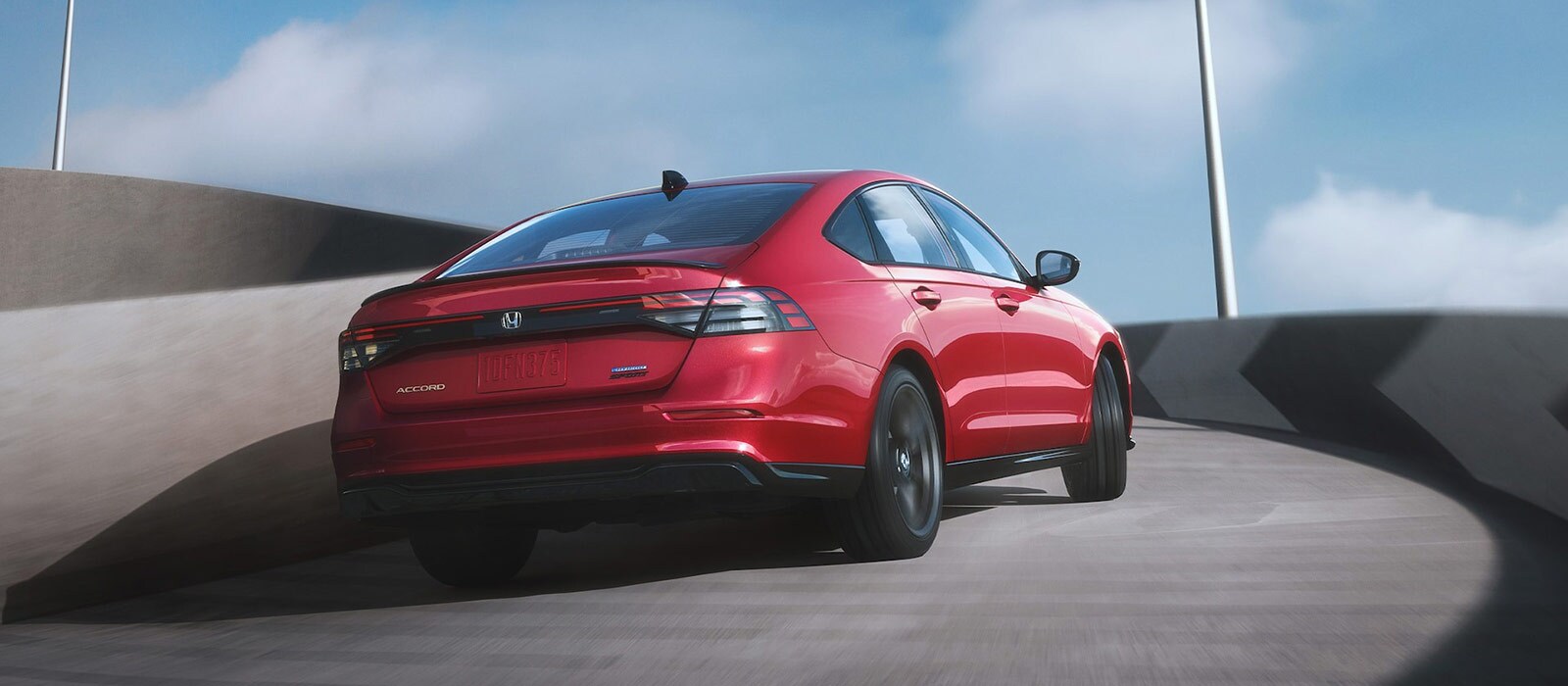 2025 Honda Accord Trim Comparison Red 2025 Honda Accord driving up a curved ramp
