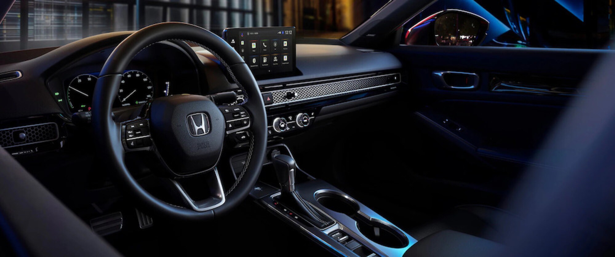 The steering wheel and dashboard of a 2026 Honda Civic sedan