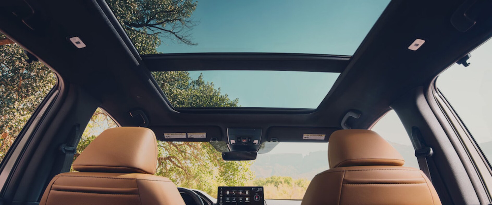The interior of the 2026 Honda Passport TrailSport Elite, featuring brown upholstery and a moonroof The interior of the 2026 Honda Passport TrailSport Elite, featuring brown upholstery and a moonroof