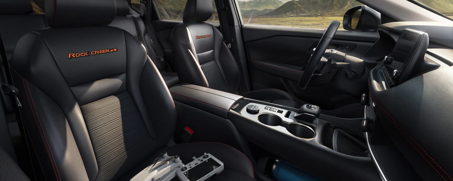 The interior of the 2026 Nissan Rogue Rock Creek, featuring black upholstered seats The interior of the 2026 Nissan Rogue Rock Creek, featuring black upholstered seats