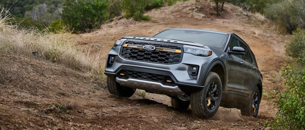 A gray 2026 Ford Explorer SUV driving up a steep incline
