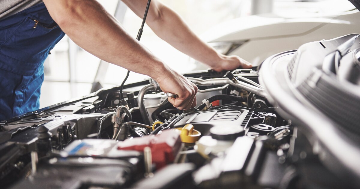 man servicing engine man servicing engine
