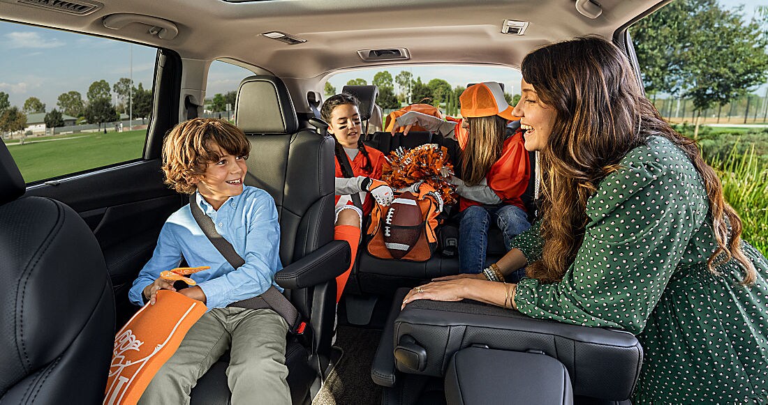 Family using the spacious second and third rows of a three-row SUV