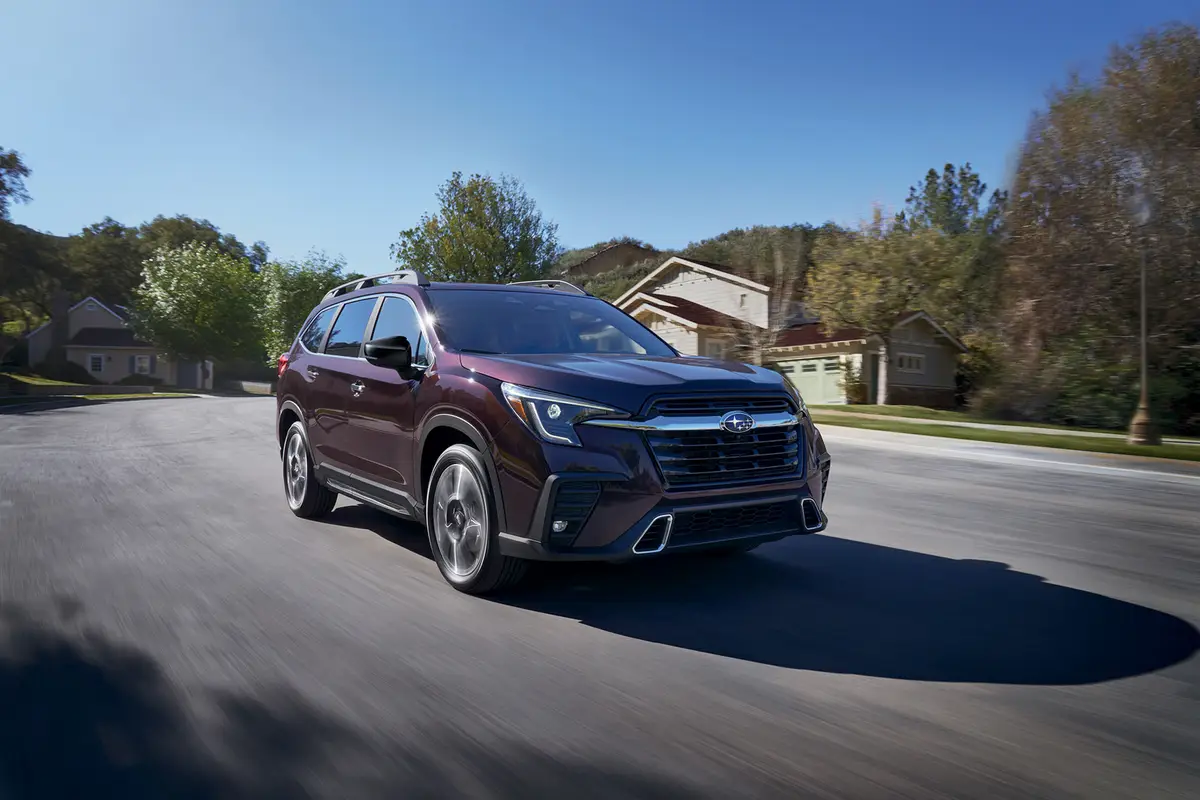 Red Subaru Ascent driving through a residential neighborhood