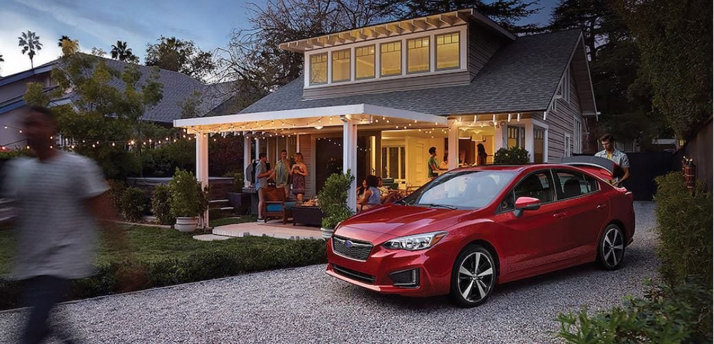 2019 Subaru Impreza red parked at home with party goers.JPG