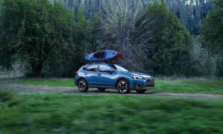 2021 Blue Subaru Crosstrek Hauling Two Canoes on the Roof