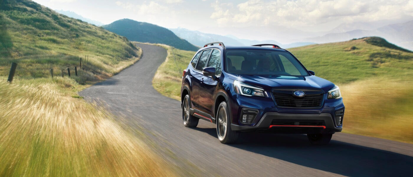 2021 Blue Subaru Forester Driving on Rolling Green Hills