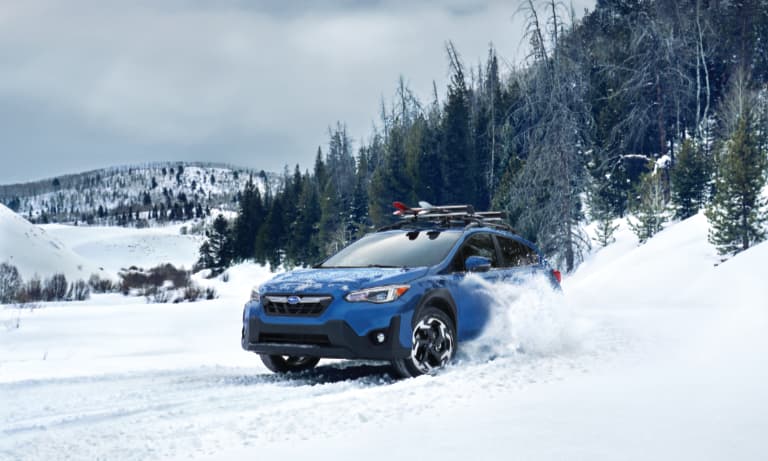 2021 Blue Subaru Crosstrek Driving in Snow