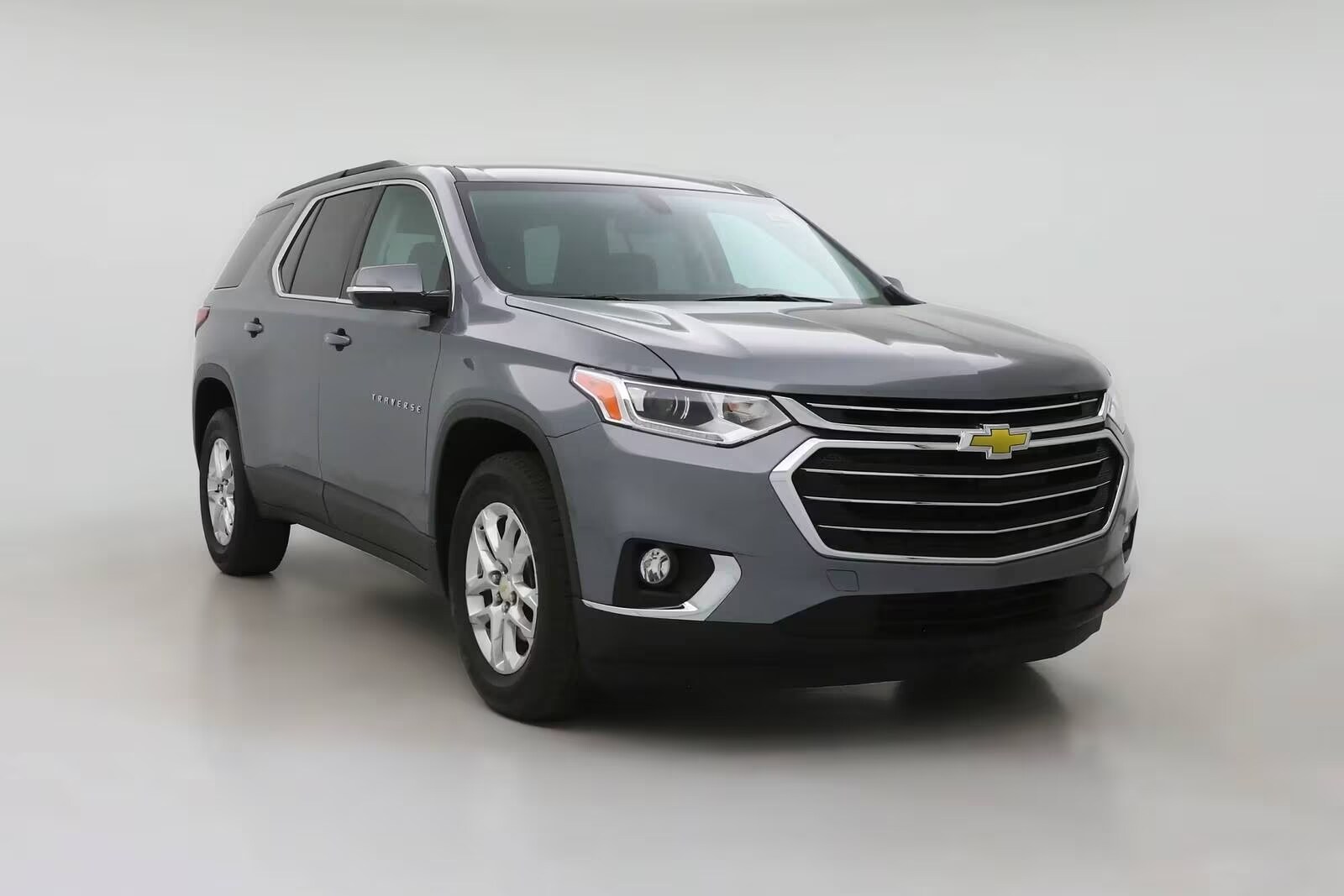 Why Buy Used From Cole Automotive Picture of a used Chevrolet Traverse in front of white wall