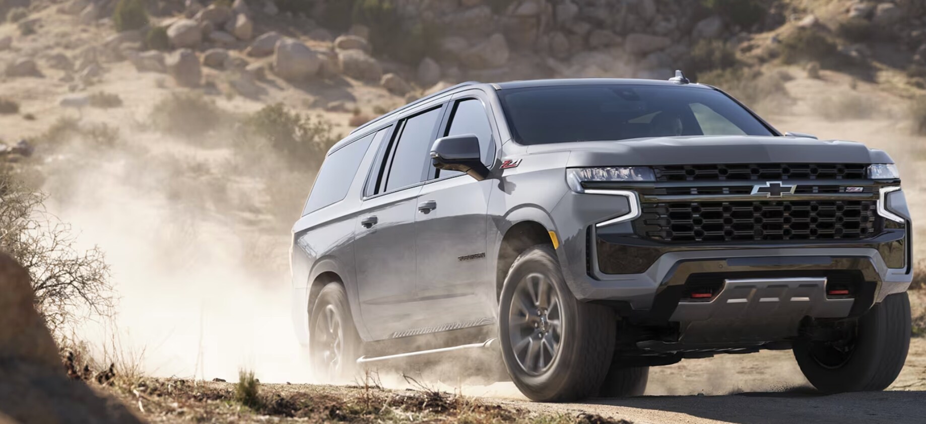 2024 Chevy Suburban on a dirt road 2024 Chevy Suburban on a dirt road
