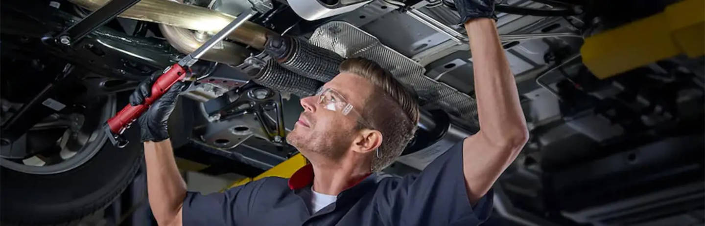 Cadillac mechanic repairing a Cadillac transmission