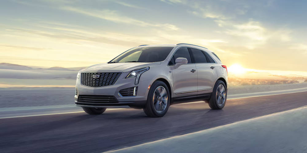 2024 Cadillac XT5 driving with sunset in background