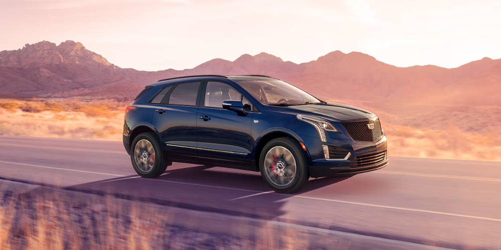 2024 Cadillac XT5 driving with sunset in background
