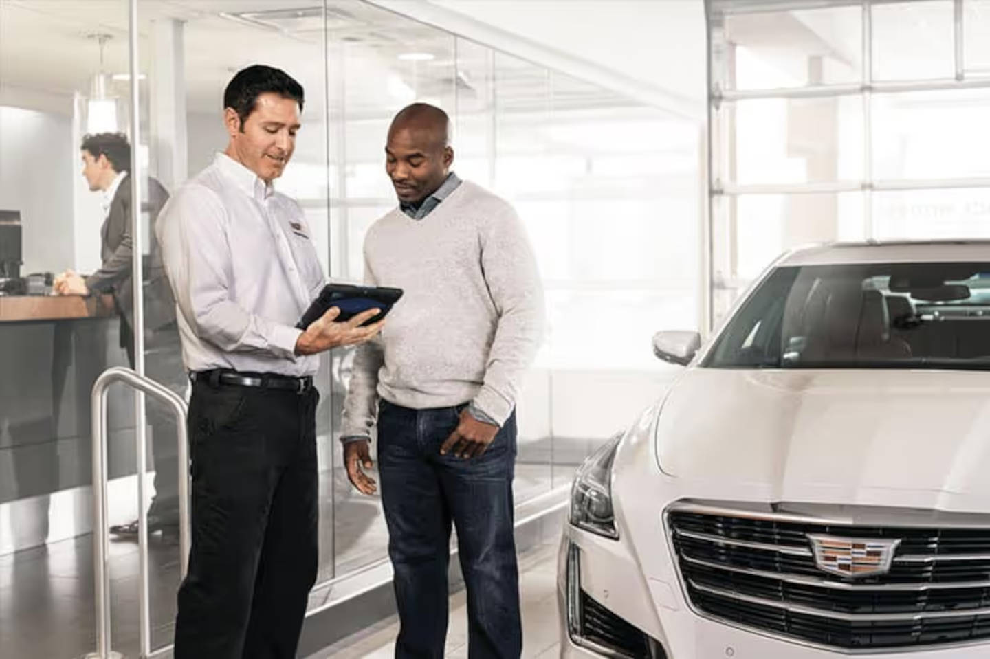 Cadillac mechanic talking to a customer