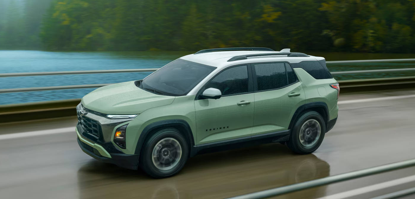 2025 Chevy Equinox driving past a lake