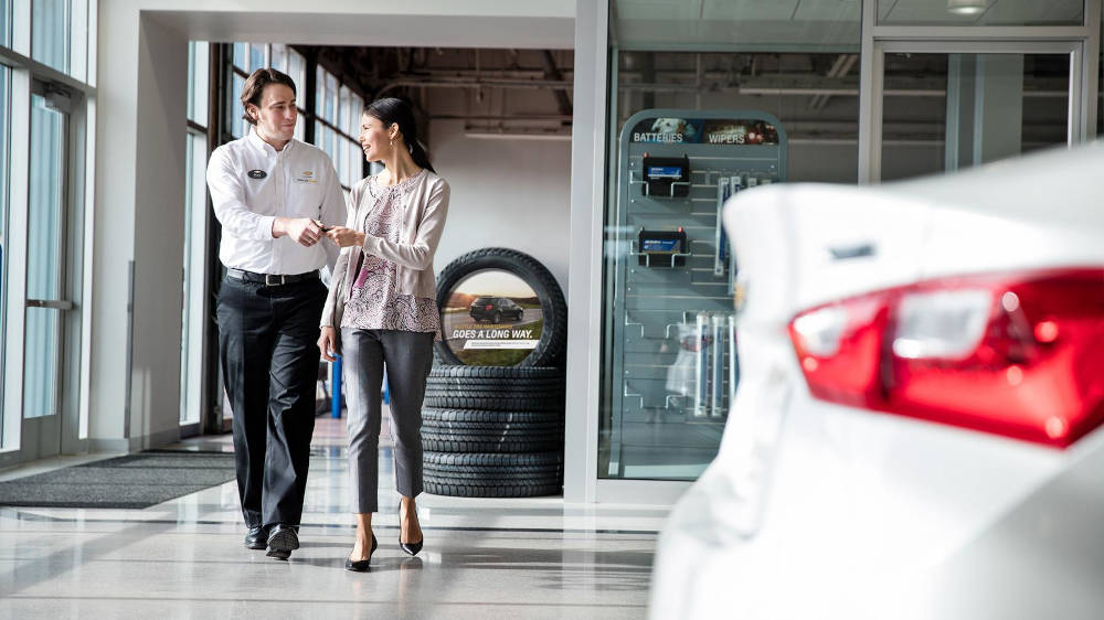 Mechanic returning Chevrolet keys to a women