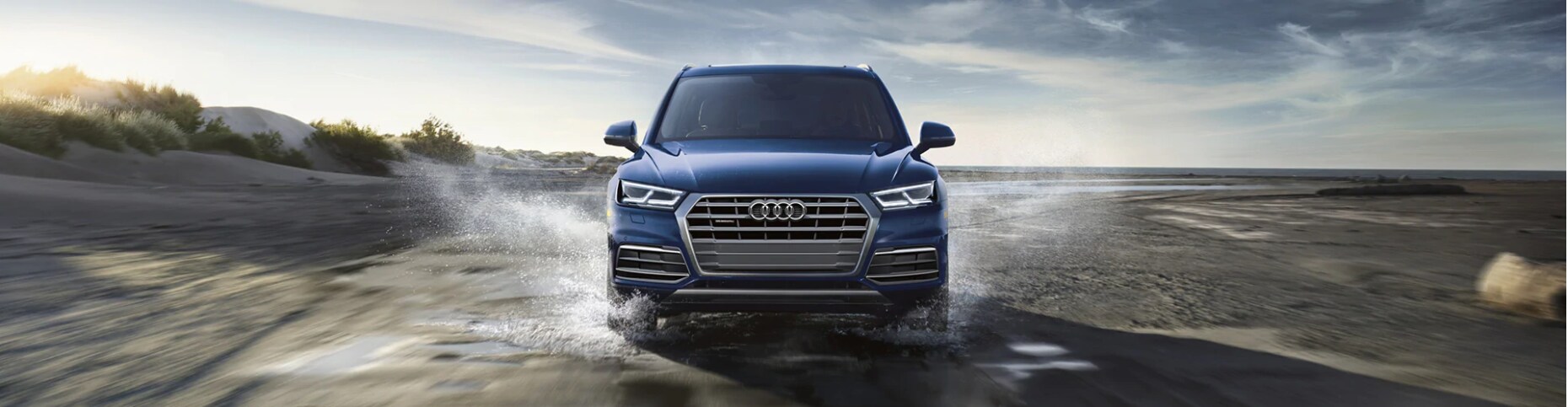 2020 Audi Q5e blue face forward splashing through water.PNG