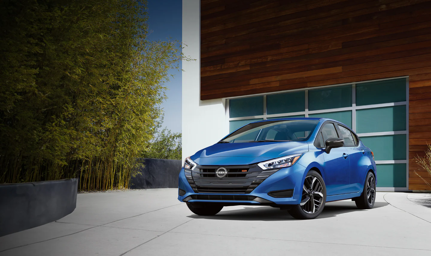 2024-nissan-versa-blue-parked-outdoors.webp