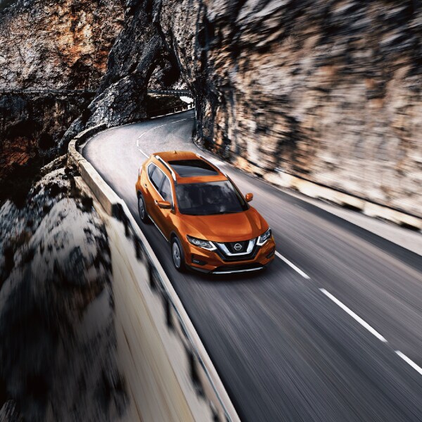 2019-Nissan-Rogue-SL-AWD-SUV-L01 (2).jpg New Nissan Rogue in Orange driving on a cliff