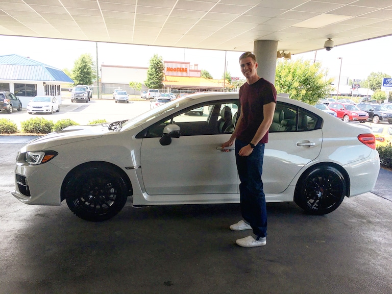 Grant in front of his first Subaru - a 2017 WRX!.jpg