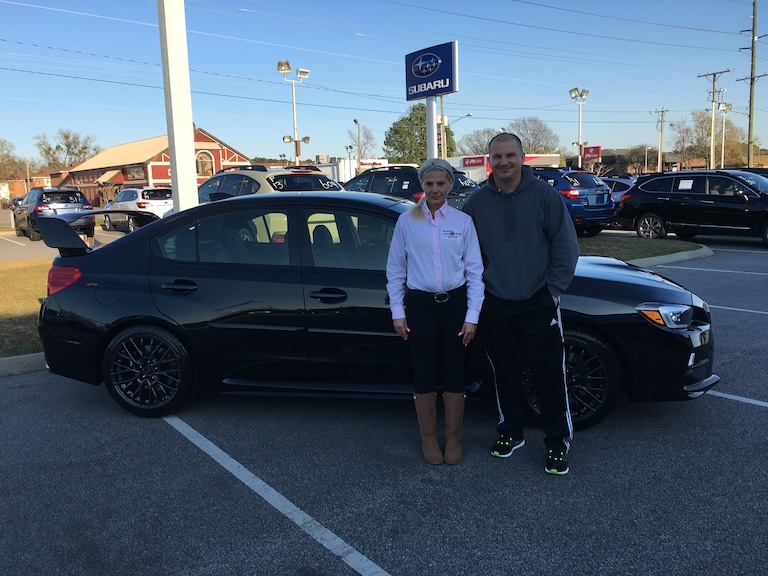 Afrim Perjuci with Sales Advisor Katey Meeks in front of his first Subaru - a 2017 WRX STI.JPG