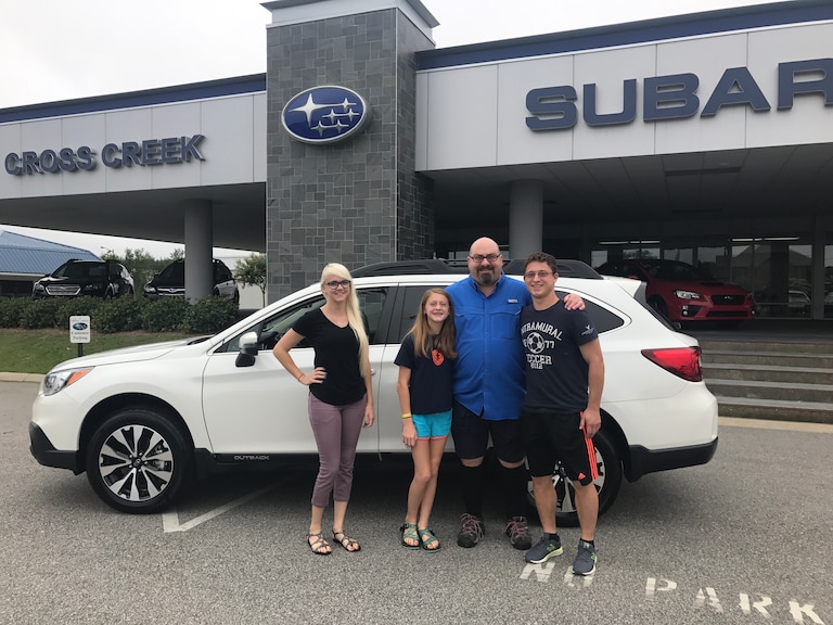 The Chiodo's (Mom not pictured) with Sales Advisor Ava in front of their new 2017 Outback.jpg