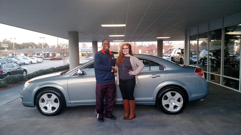 Darrell Loving with Senior Sales Advisor Emily Bracey and his 2009 Saturn.jpg