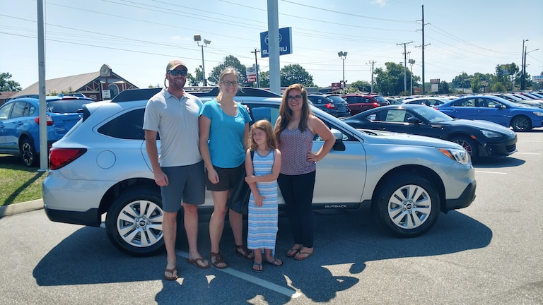 The O'Callahans with Sr Sales Advisor Emily in front of their 2nd Subie - a 2017 Outback.jpg