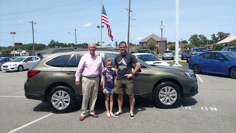 Josh with his daughter and Sales Advisor, Myc, in front of his new 2017 Outback.jpg