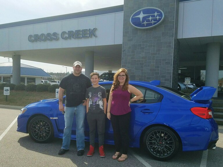 Chance and his son Cole with their new 2017 WRX STI and Sr Sales Advisor Emily Bracey.jpg