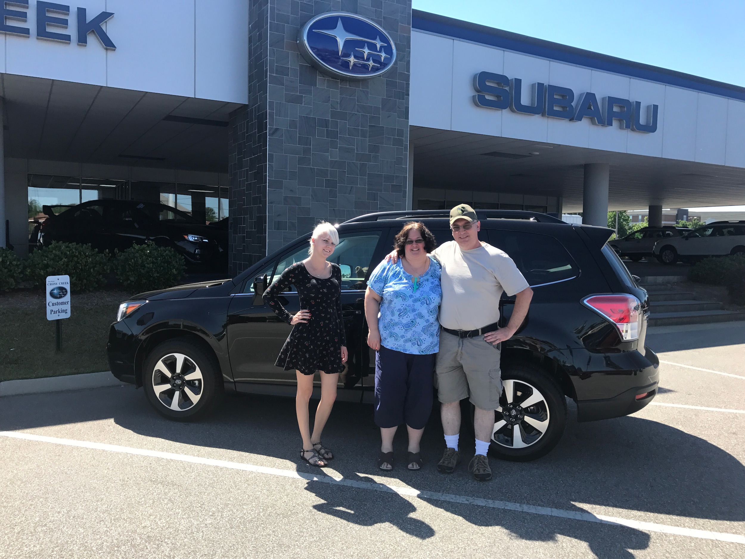 Kevin & Jennifer with Sales Advisor Ava in front of their 4th Subaru! -a 2017 Forester.JPG
