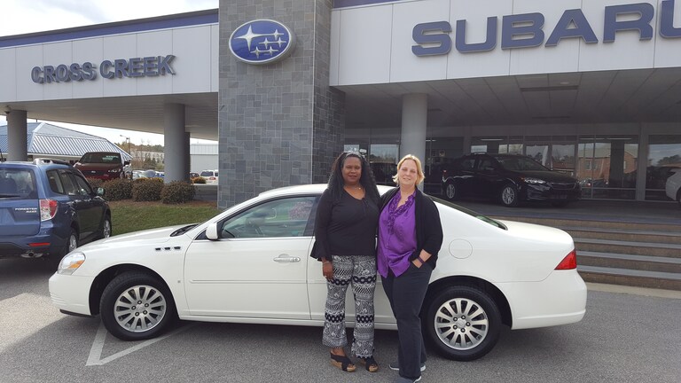 Tina with Sales Advisor Kristen in front of her 2006 Buick Lucerne from the #crosscreekpreowneds.jpg