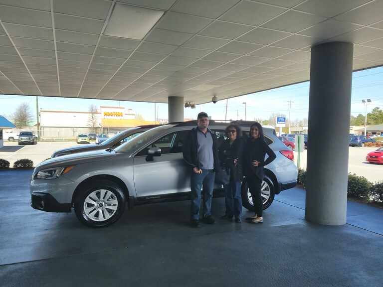Mr & Mrs Moffitt in front of their 2017 Outback with Sales Advisor Leidy Rhines.jpg