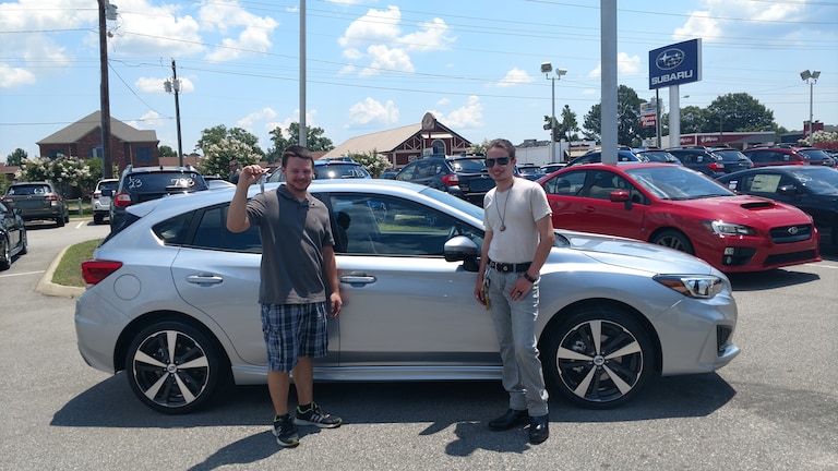 Christopher shows off his first Subaru - a 2017 Impreza - with his brother!.jpg