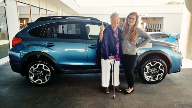 Shirley Dean with her new Crosstrek and Emily Bracey.jpg