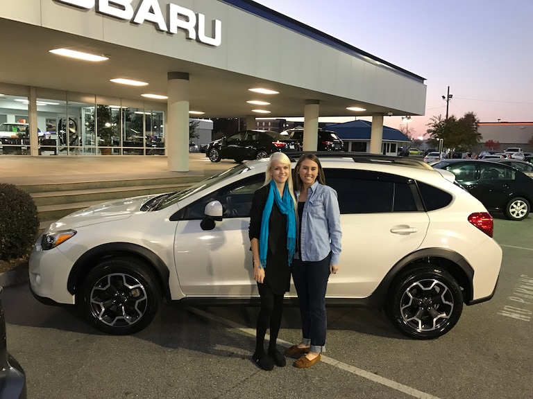 Elizabeth with Sales Advisor Ava in front of the Subaru she just purchased - a 2014 Crosstrek!.JPG