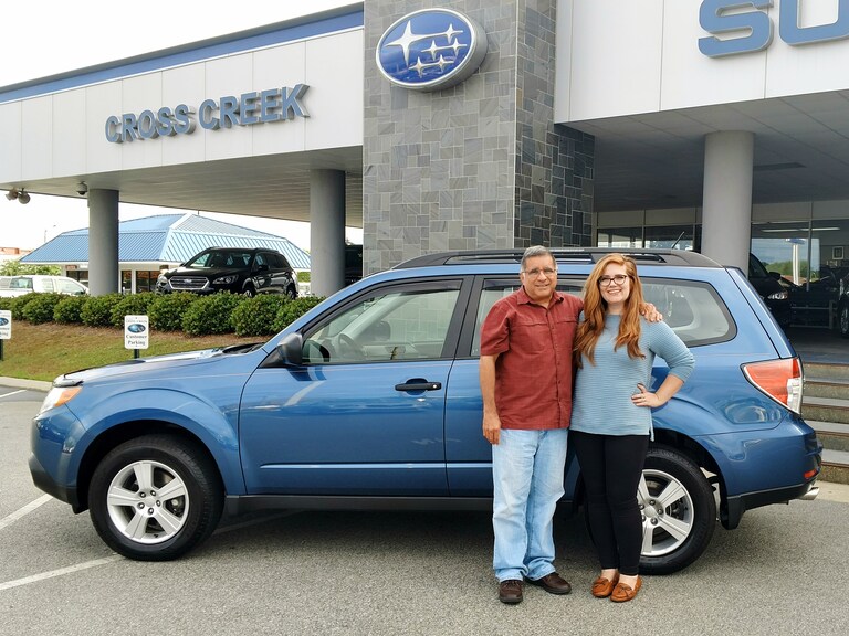 Gama with Sr Sales Advisor Emily in front of his 2012 Subaru Forester.jpg