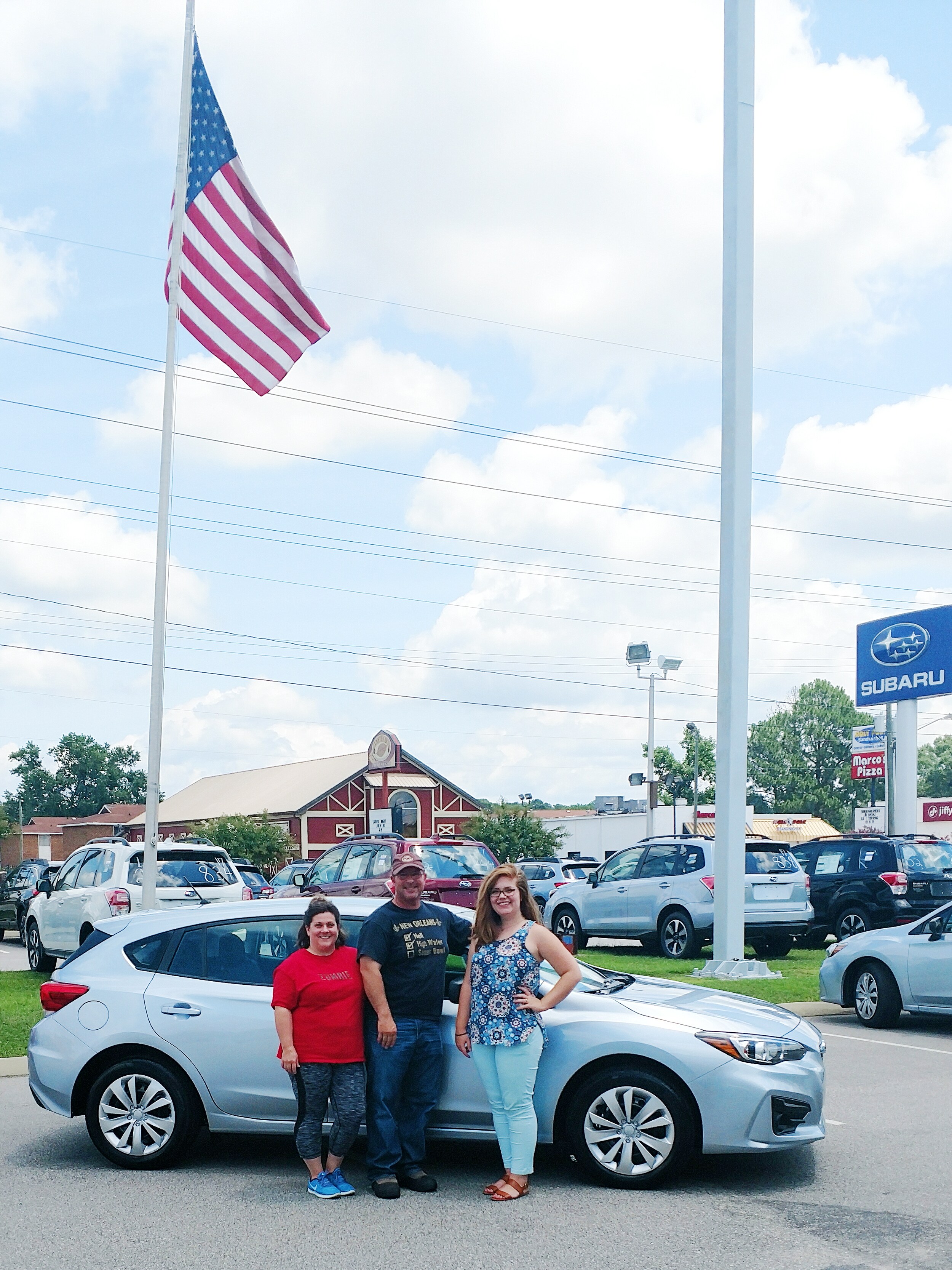 Mr & Mrs Lopez with Sr Sales Advisor in front of their new 2017 Impreza.jpg