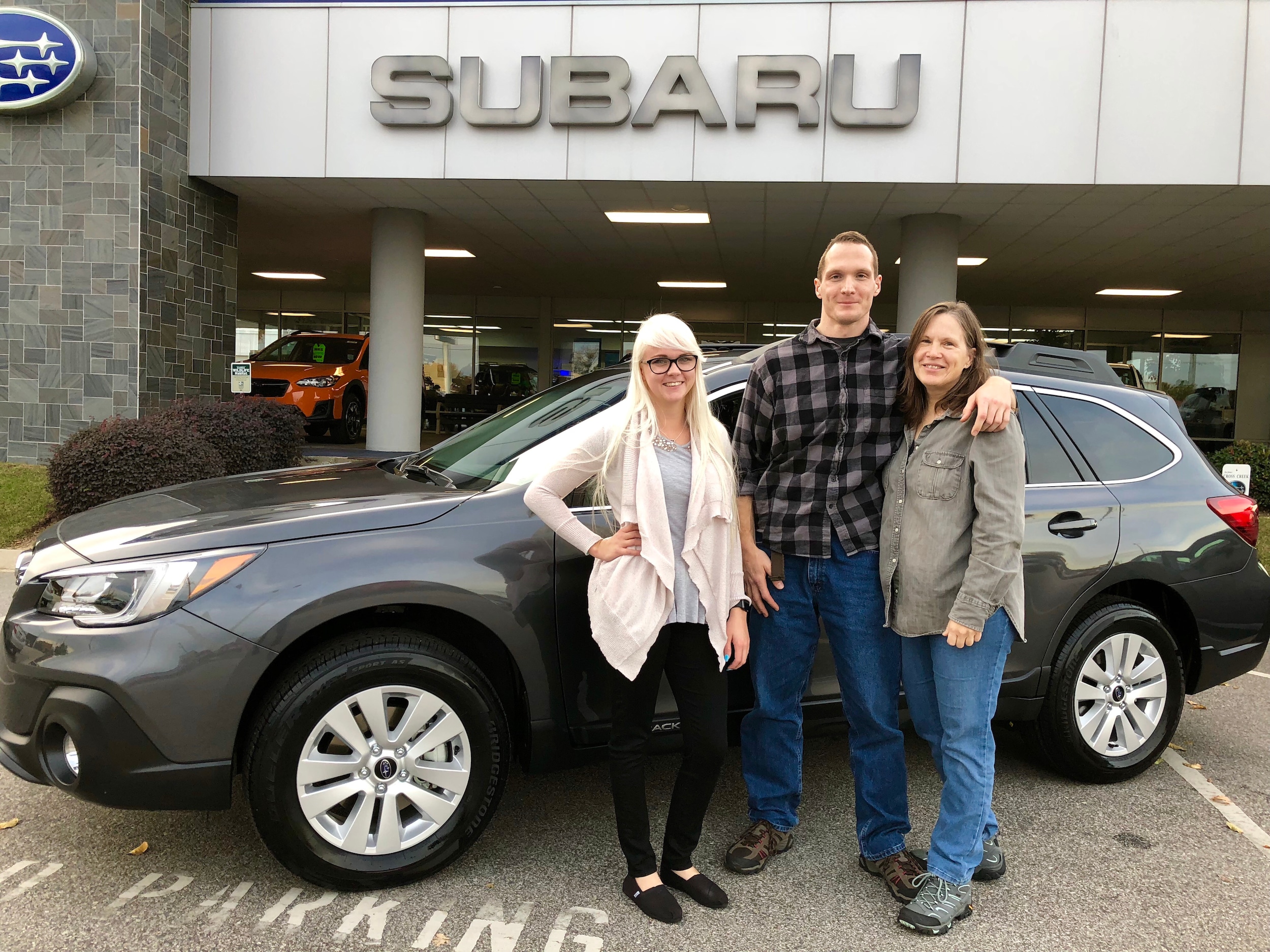 Kyle, his mom and sales advisor Ava in front of his new 2018 Outback.jpg