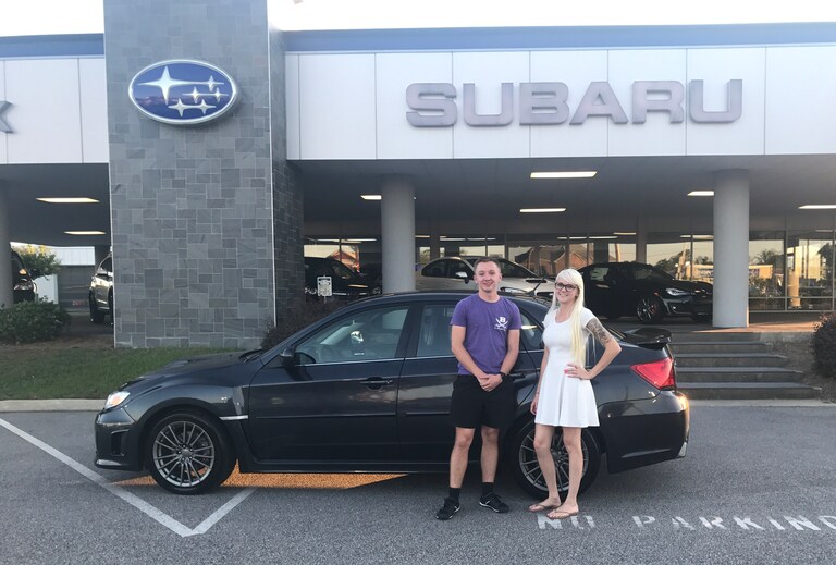 Aaron with Sales Advisor Ava in front of the 2014 CPO WRX his parents surprised him with!.JPG