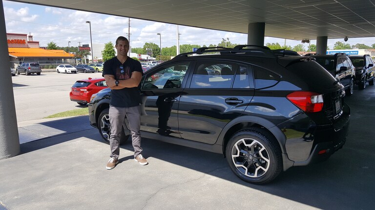 Peter with his first Subaru - a 2016 Crosstrek!.jpg